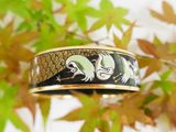 a bracelet with a picture of two birds on it