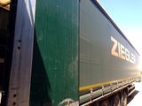 a green semi truck that is parked on the side of the road