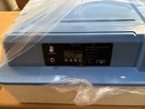 un récipient en plastique muni d'un couvercle, posé sur une table