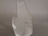 a clear glass vase on a table with a white background