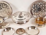 a lot of silver items that are sitting on a table
