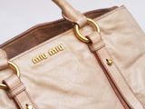 a close up of a purse with a handle on it