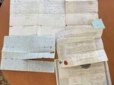 a table that has a bunch of old papers on it