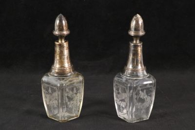pair of antique glass salt and pepper shakers on a black background
