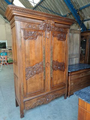 a wooden armoire with a marble top in a room