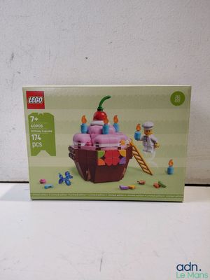 a box of legos with a cupcake on it