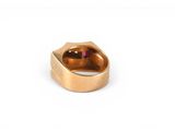 an image of a gold ring with a pink stone in the middle
