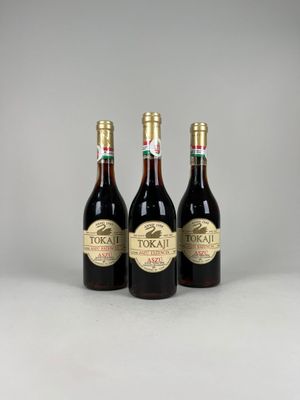 three bottles of wine sitting next to each other on a table