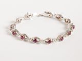 a close up of a bracelet with red stones on it