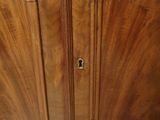 a close up of a wooden cabinet with a lock on it