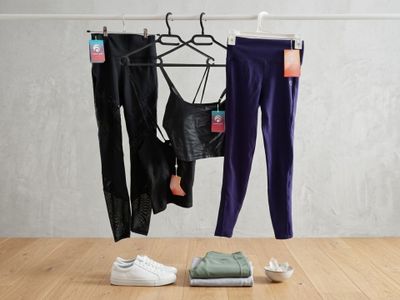 two pairs of pants and a pair of sneakers on a table