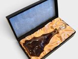 a bottle of liquor in a box on a white surface