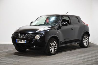 the black nissan juke is parked in a room with a checkered floor