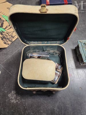 a suitcase with a watch inside of it on the floor