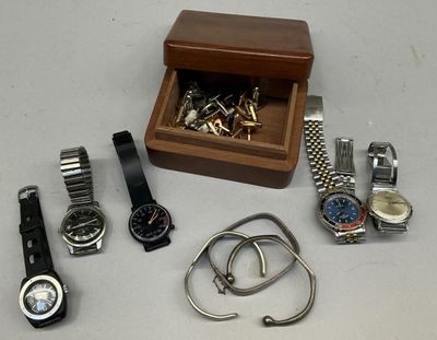 many watches and bracelets laid out on a table