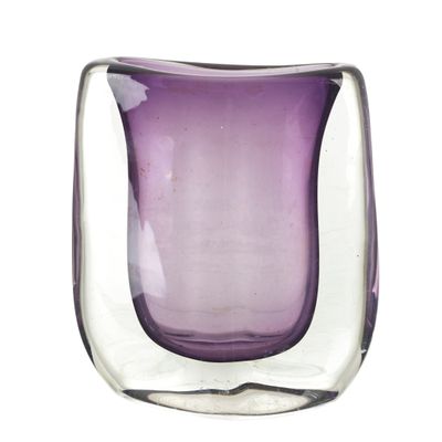 a purple glass vase sitting on a white surface