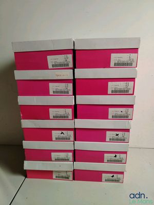 a stack of pink boxes sitting on top of a white table