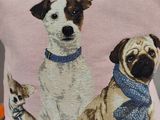a pillow with a picture of two dogs and a cat on it