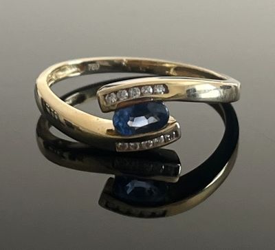 an image of a close up of a ring with a blue stone