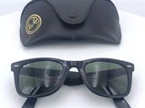 pair of ray bans sunglasses with black case on white surface