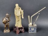 a statue of a man holding a sword next to other statues