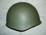a green helmet on a white sheet on a table