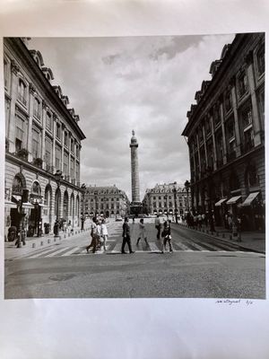 black and white photograph of people crossing the street in front of a clock tower