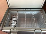 a cooler that is sitting on the floor with wires in it