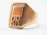 an image of a gold signet ring with the letter r on it