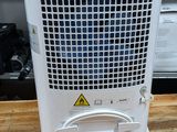 a small air conditioner sitting on top of a wooden table