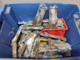 a blue bin filled with plastic items and a red container