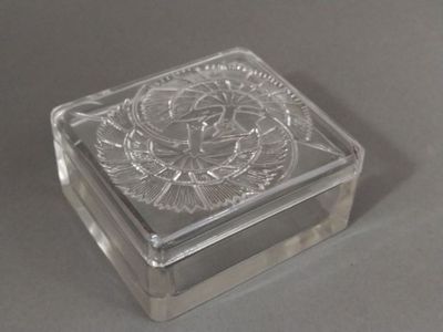 a glass box with a design on it on a table