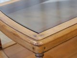 a glass top coffee table on a wooden shelf