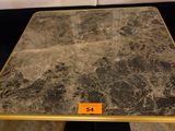 a marble table with a gold frame on it