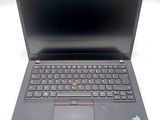 the laptop is open on a white surface with a black keyboard