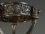 a silver cup with a dog on it on a stand