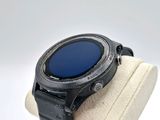 a smart watch on display on a white display stand