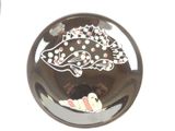 a black button with a fish design on it