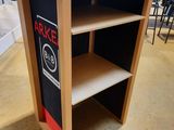 a wooden table with a black and red sign on it