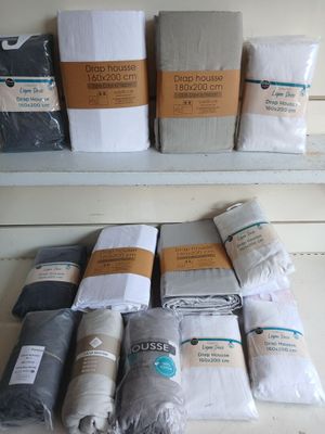 many different types of blankets on a shelf