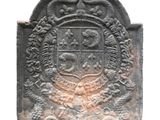 a stone plaque with a coat of arms on it