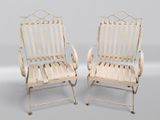 une paire de chaises de jardin en fer blanc, montées sur roulettes, avec accoudoirs et pieds