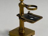 a brass plate with a pair of scissors on top of it