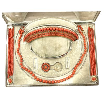 an orange beaded necklace and bracelet set in a silver box