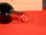 a bottle of wine on a red table cloth