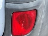 a close up of a car ' s tail light with a sticker on it