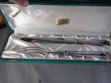 a silverware set in a green case on a table