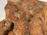 an image of a wooden carving of an eagle with a bird on it ' s back