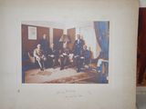 an old photo of a group of people sitting in a room