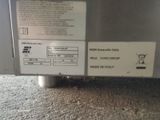 a label on the side of a machine that is sitting on the floor